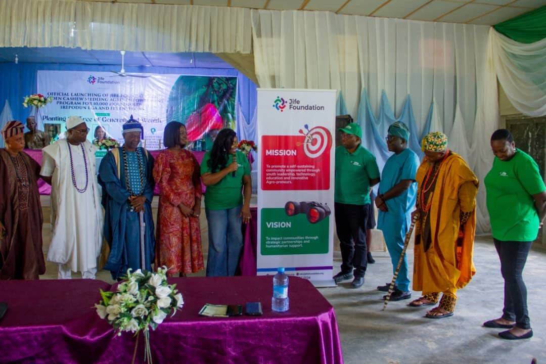 Dignitaries and JIFE Foundation staff on stage at the launch of the cashew seedling programme, beside a banner reading Planting the Tree of Generational Wealth.